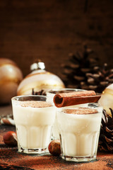 Eggnog with milk, cinnamon, grated nutmeg, decorated with fir co