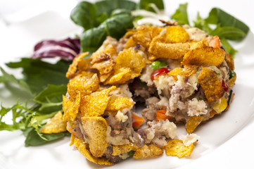 Pork cake broken to show filling