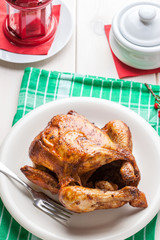 Baked chicken on white plate.