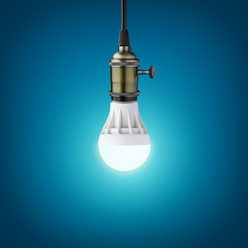 Glowinng LED bulb on blue background