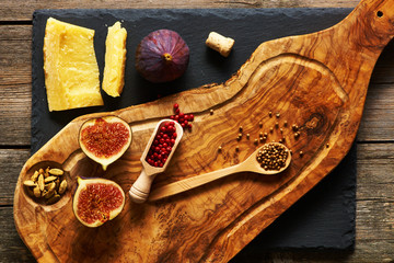 Olive wood cutting board with spices and fig