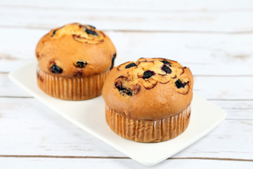 Blueberries muffins on wooden background