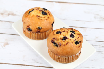 Blueberries muffins on wooden background