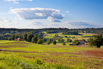 Fototapeta na wymiar Rural landscape with a Farm and a fileld