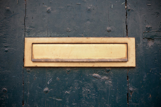 Dark green door with letter slot mailbox