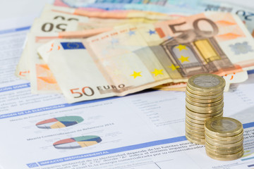 Close up of utility bill and coins for payment. 
