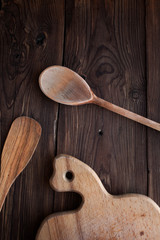 Wood spoon with kitchen tools on old table