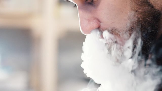 Man Exhaling smoke from a vaporizer shot in slow motion