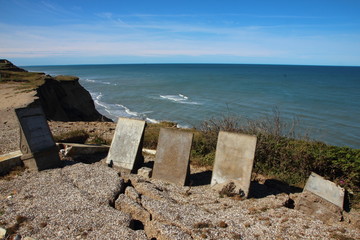 Ancient Headstones at Edge of Cliff with Erosion Cracks