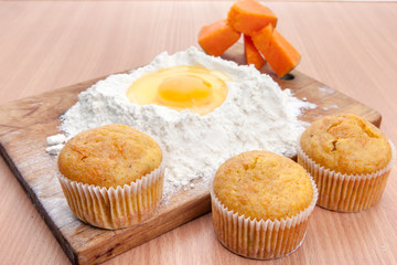 Cupcakes, flour and egg on kitchen table