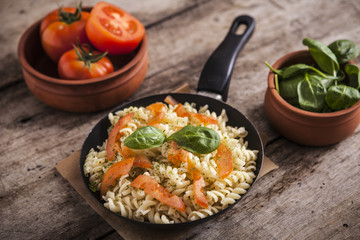 Whole wheat pasta with vegetables on cast iron pan