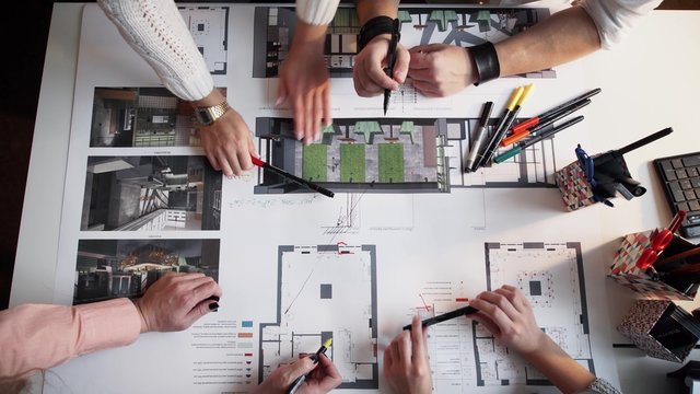 Top view of architects hands drawing of modern house with material sample