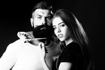 Woman cuttin male beard