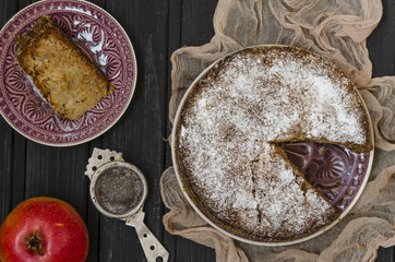Apple charlotte with semolina topped with powdered sugar   