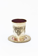 Silver cup with red wine