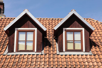 tiled roof and garret windows in old house - 96263321