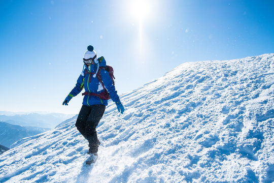 woman descending from snowy mountains