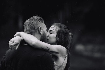 beautiful couple hugging in the rain