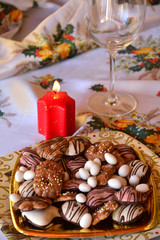 Christmas decorated gingerbread cookies on the table with lighted candle
