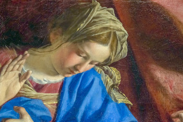 A detail of an old cracked painting of the Virgin Mary in the moment of Anunnciation