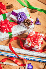 Objects for wrapping Christmas presents on wooden background 