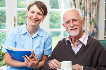 Senior Man With Carer At Home