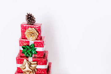 christmas presents in shape of christmas tree on white background 