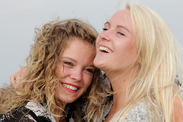 Fototapeta premium two beauty girls laughing and hugging