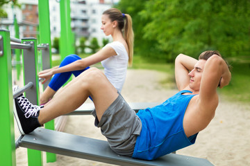Couple exercising at outdoor gym
