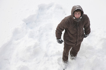 Fototapeta na wymiar Top view of a man standing in a snowy field