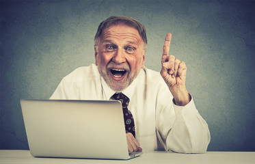 excited senior man using laptop computer has an idea