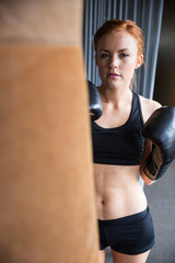 Female boxer working out with bag