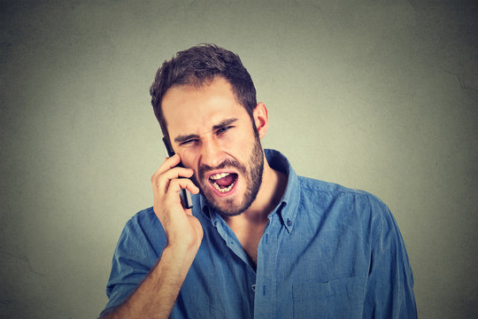 angry man, mad worker, pissed off employee shouting while on phone