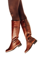 woman legs wearing brown leather high boots