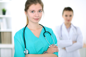 Portrait of young female surgeon doctor in a hospital