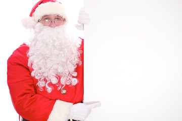 Kind Santa Claus pointing in white blank sign, isolated on white background