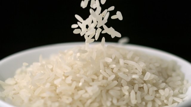 Pouring rice into plate shooting with high speed camera.