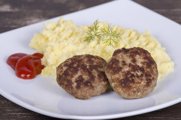 Fried cutlet with mashed potatoes on a white plate