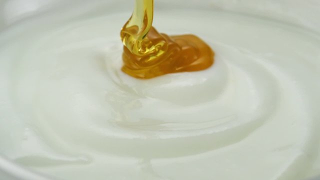 Honey pouring on yogurt shooting with high speed camera.