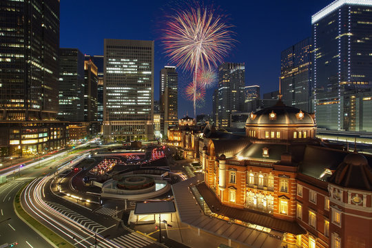 Tokyo train station building and beautiful firework
