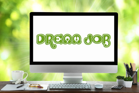 Dream job concept. Computer on nature green background