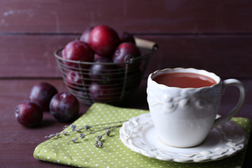 Delicious plum juice with fruits on wooden table close up
