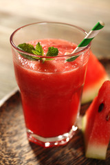 Glass of watermelon juice on wooden table, closeup