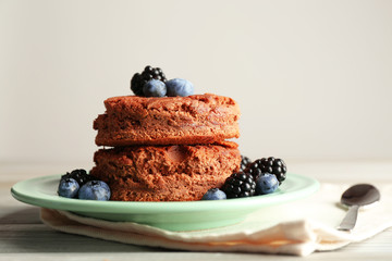 Cake with berries on wooden table