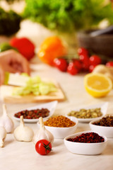 Variety of spices in ceramic containers on the kitchen table