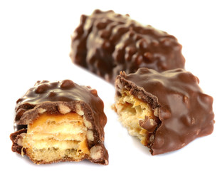 Tasty broken chocolate bars isolated on white background