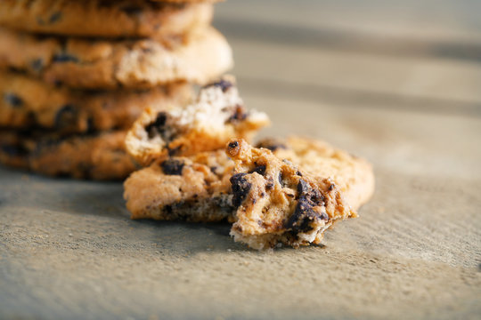 Cookies with chocolate crumbs on wooden table, close up