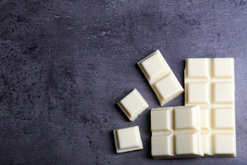 White chocolate pieces on gray background
