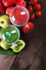 Fresh juice mix fruit, healthy drinks in plastic cups on wooden background