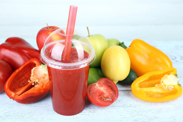 Fresh juice mix fruit and vegetables, healthy drink on wooden table, on light background